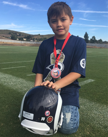 TAPS boy with LA Rams helmet