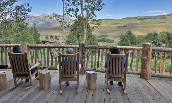 Survivors relax in rocking chairs at Montana Retreat