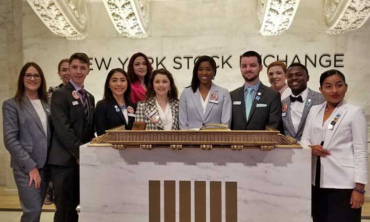 Jaisha Haynes, center, and a group of young adult survivors toured the trading floor at the New York Stock Exchange