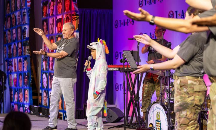 General Dempsey on stage acting out the Unicorn Song General Dempsey on stage acting out the Unicorn Song