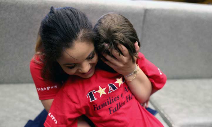 Good Grief Camp Boy getting hug from mother