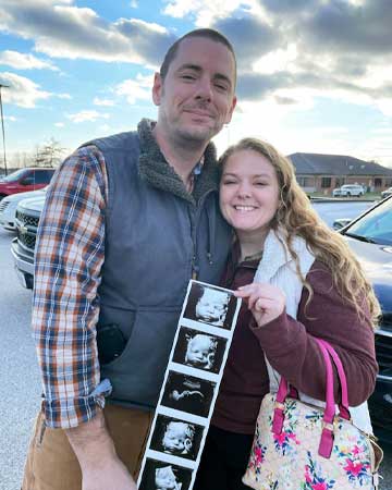 Rachel and spouse with ultrasound photos